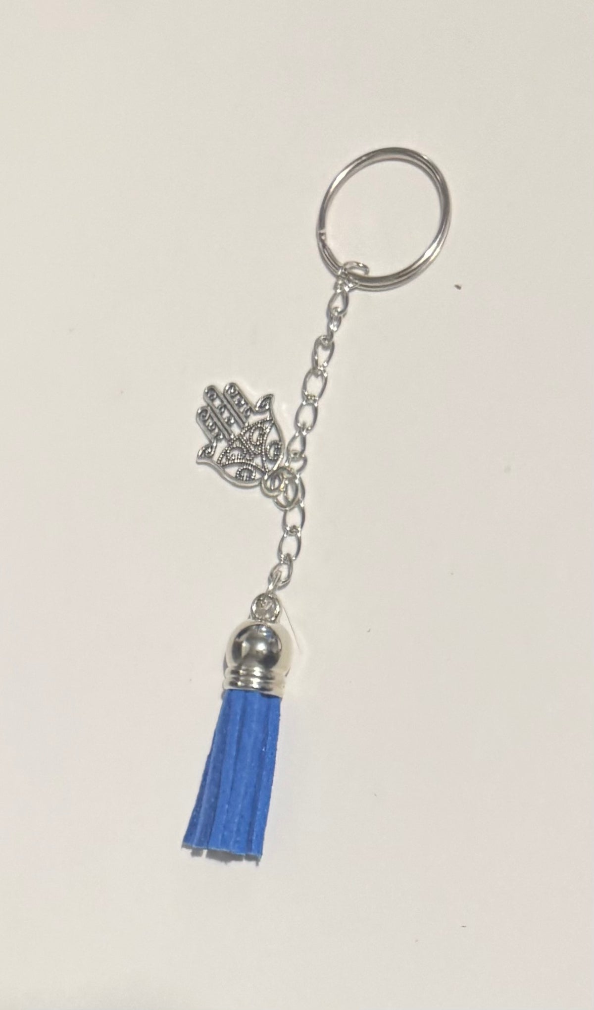 Red tassel keyring with silver four-leaf clover charm